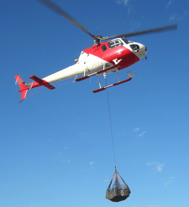 Image of Helicopter using a longline to lift heavy item